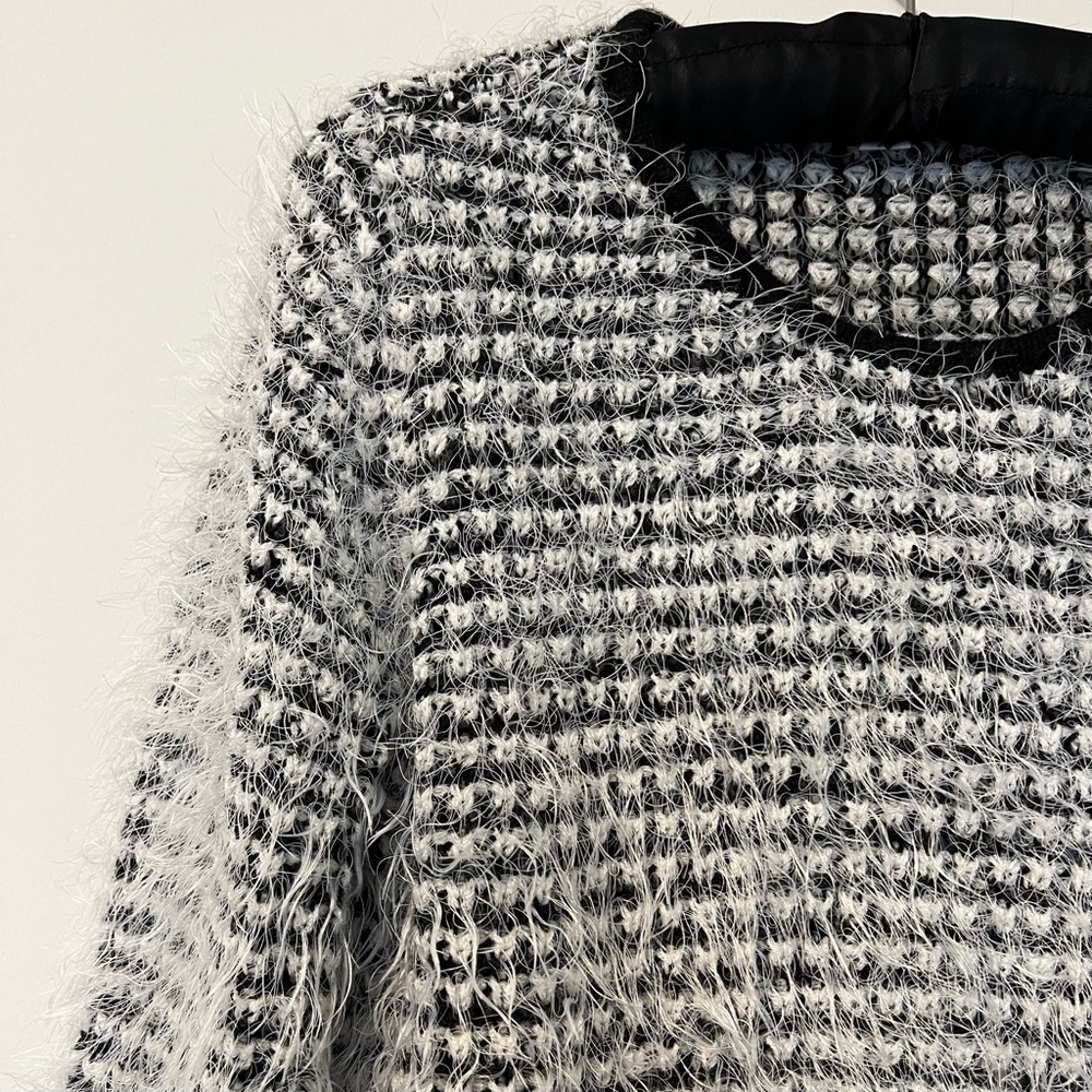 Fuzzy black and white sweater.